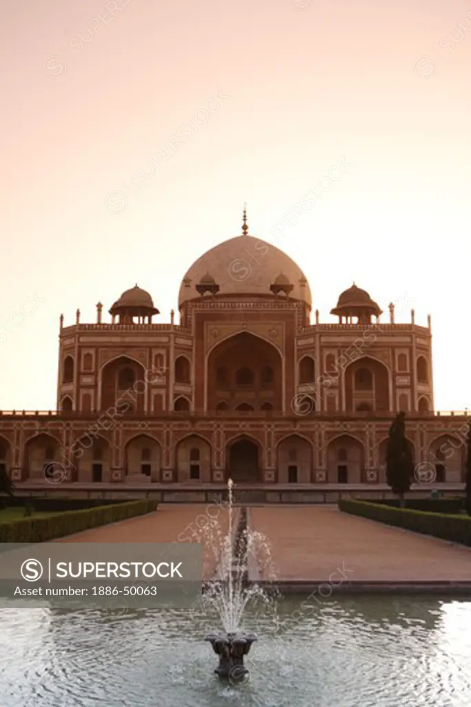 Sunrise at Humayun's tomb built in 1570 made from red sandstone and white marble first garden-tomb on the Indian subcontinent persian influence in mughal architecture ; Delhi ; India UNESCO World Heritage Site