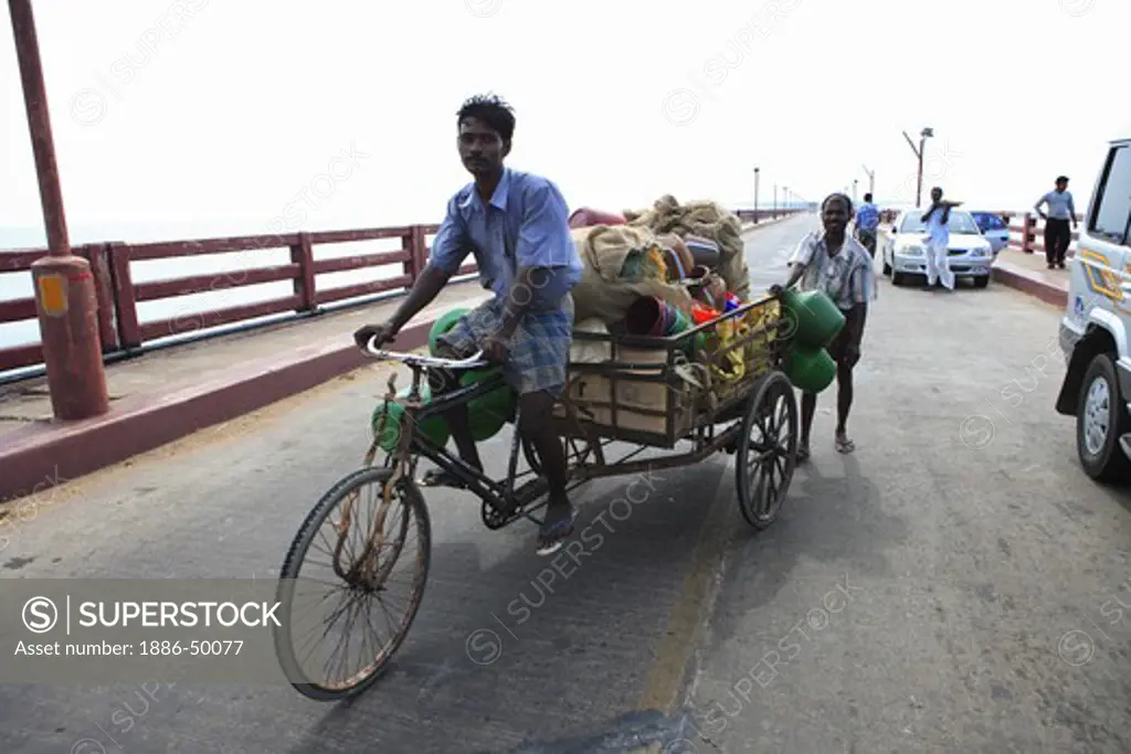 Man riding tricycle on Indira Gandhi bridge ; Rameswaram small island in Gulf of Mannar ; Tamil Nadu ; India