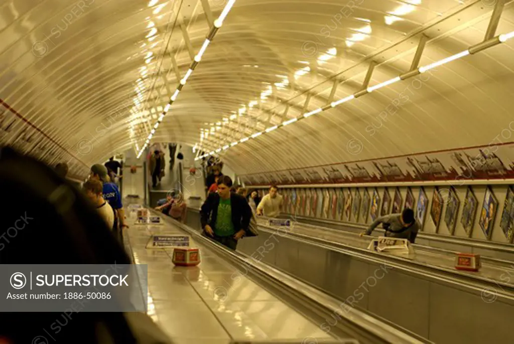 Tube station ; passengers on escalators ; Piccadilly Circus London ; U.K. United Kingdom England