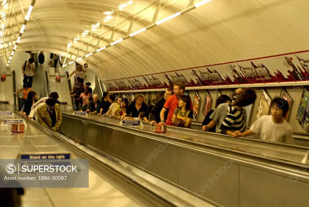 Tube station ; passengers on escalators ; Piccadilly Circus London ; U.K. United Kingdom England
