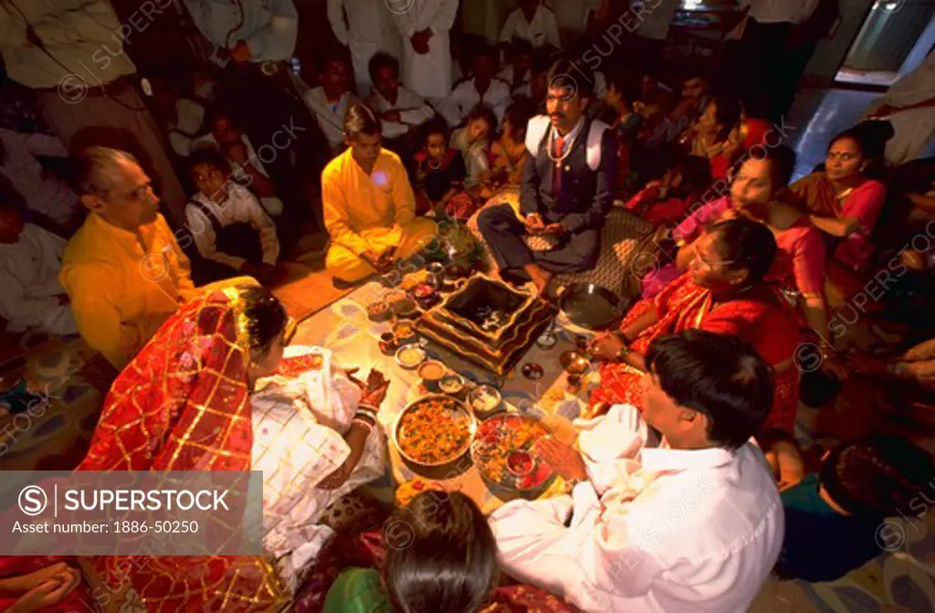 Bride, groom and guests at Gujrati Brahmin wedding ceremony, India.