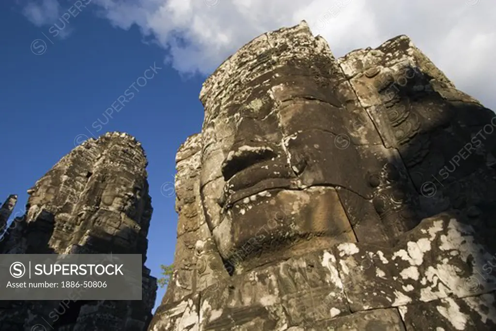 The face towers of The Bayon at Angkor Thom, the largest Khmer city ever built, are part of the Angkor Wat complex  -  Siem Reap, Cambodia