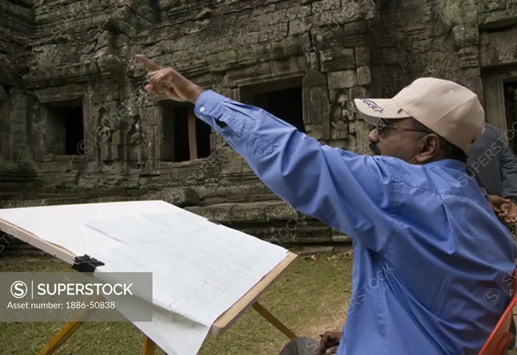 An archaeologist works to rebuild the Khmer ruins of Ta Prohm, built by Jayavarman VII, part of Angkor Wat - Siem Reap, Cambodia