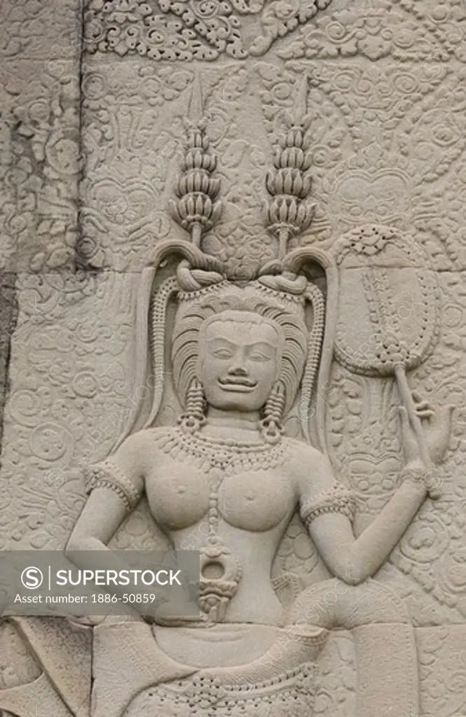 A stone carved bas relief Apsara (celestial maidens) at Angkor Wat, built in the 11th century by Suryavarman the 2nd,  -  Cambodia