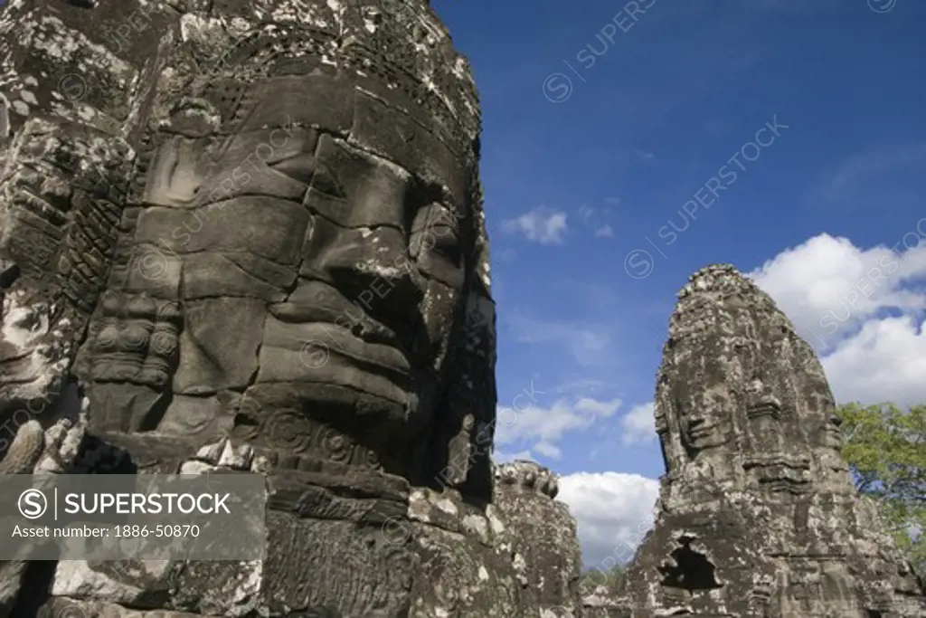 The face towers of The Bayon at Angkor Thom, the largest Khmer city ever built, are part of the Angkor Wat complex  -  Siem Reap, Cambodia
