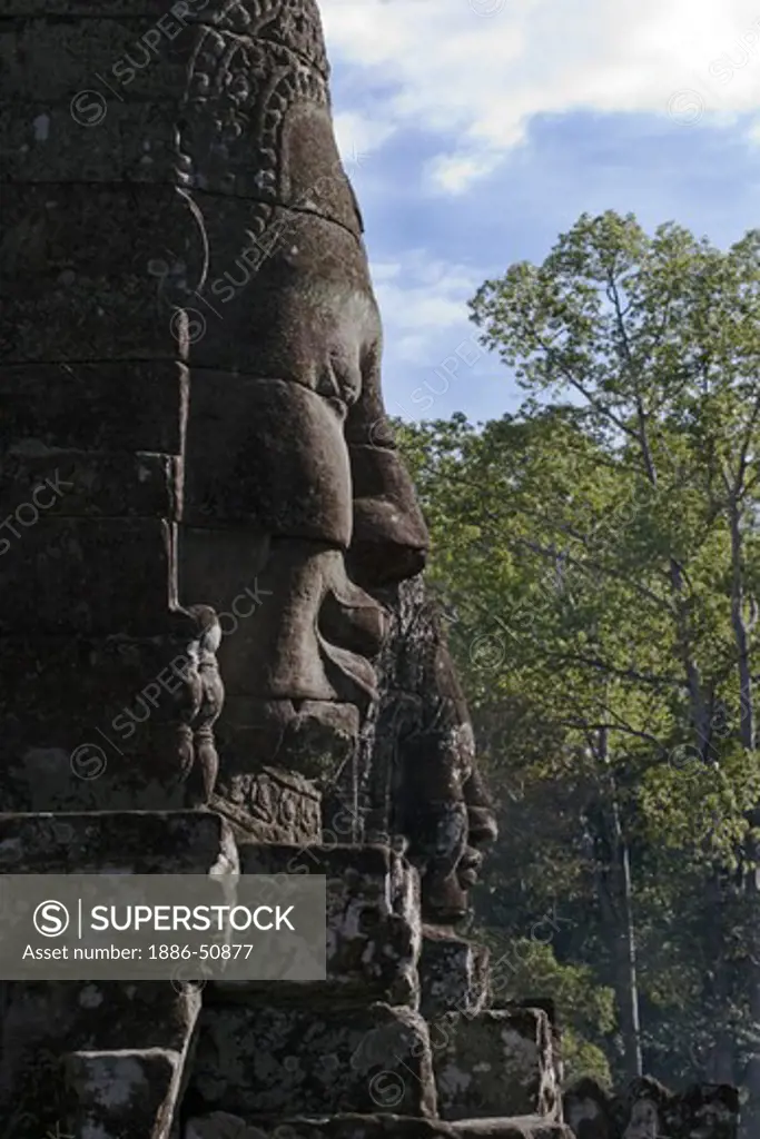 View of two  face towers of The Bayon at Angkor Thom, the largest Khmer city ever built, are part of the Angkor Wat complex  -  Siem Reap, Cambodia