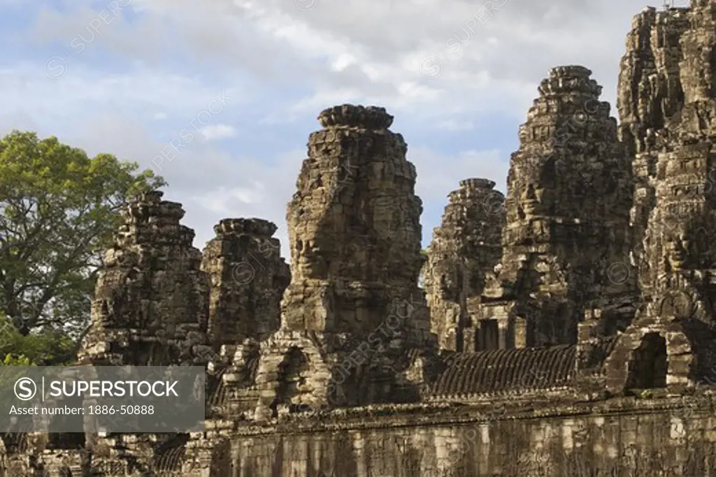 Stone face towers of The Bayon at Angkor Thom, the largest Khmer city ever built, are part of the Angkor Wat complex  -  Siem Reap, Cambodia