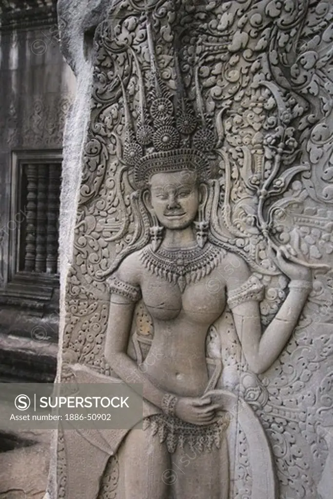 A stone carved bas relief Apsara (dancing celestial maiden) at Angkor Wat, built in the 11th century by Suryavarman the 2nd,  -  Cambodia