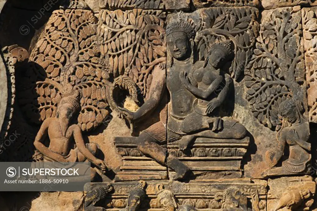 Banteay Srei with bas relief in red sandstone of the Hindu Gods Shiva & Parvati, 10th century Khmer architecture at Angkor Wat -  Siem Reap, Cambodia