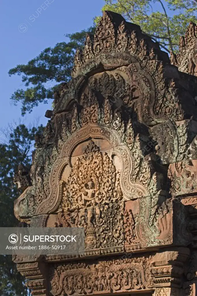 Bas relief in red sandstone of the West Gopura in the inner enclosure of Banteay Srei, 10th century Khmer architecture at Angkor Wat -  Siem Reap, Cambodia