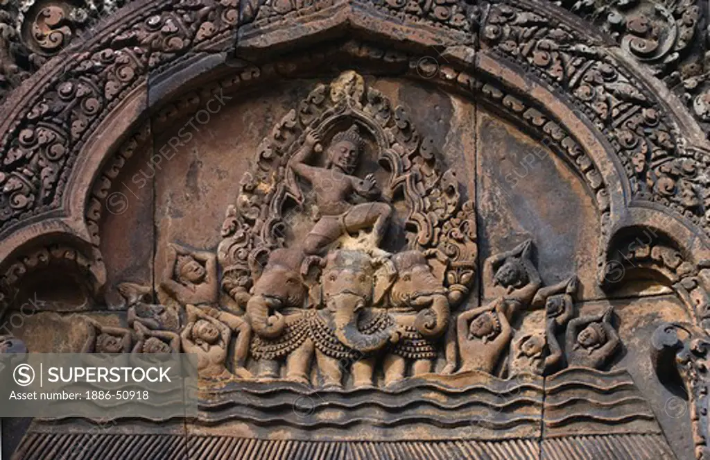 Bas relief in red sandstone of Indra riding his three headed elephant on the East Pediment of the North Library at Banteay Srei, 10th century Khmer architecture at Angkor Wat -  Siem Reap, Cambodia