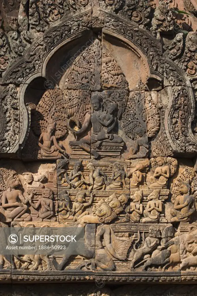 Banteay Srei with bas relief in red sandstone showing Ravana shaking Mount Kailasa & Shiva & Parvati (E pediment of S Library), 10th century Khmer architecture at Angkor Wat -  Siem Reap, Cambodia