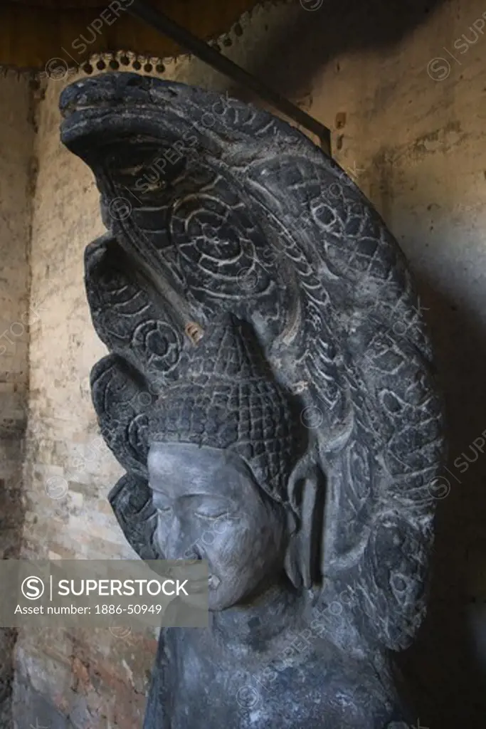 Statue of the Buddha with nagas at East Mebon, built by Rajendravarman in the10th century - Angkor Wat, Siem Reap, Cambodia