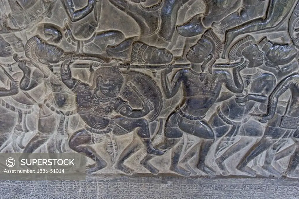 Stone carved bas relief of Kauravas warriors with enemies head in the south west corner pavilion at Angkor Wat, built in the 11th century by Suryavarman the 2nd,  -  Cambodia