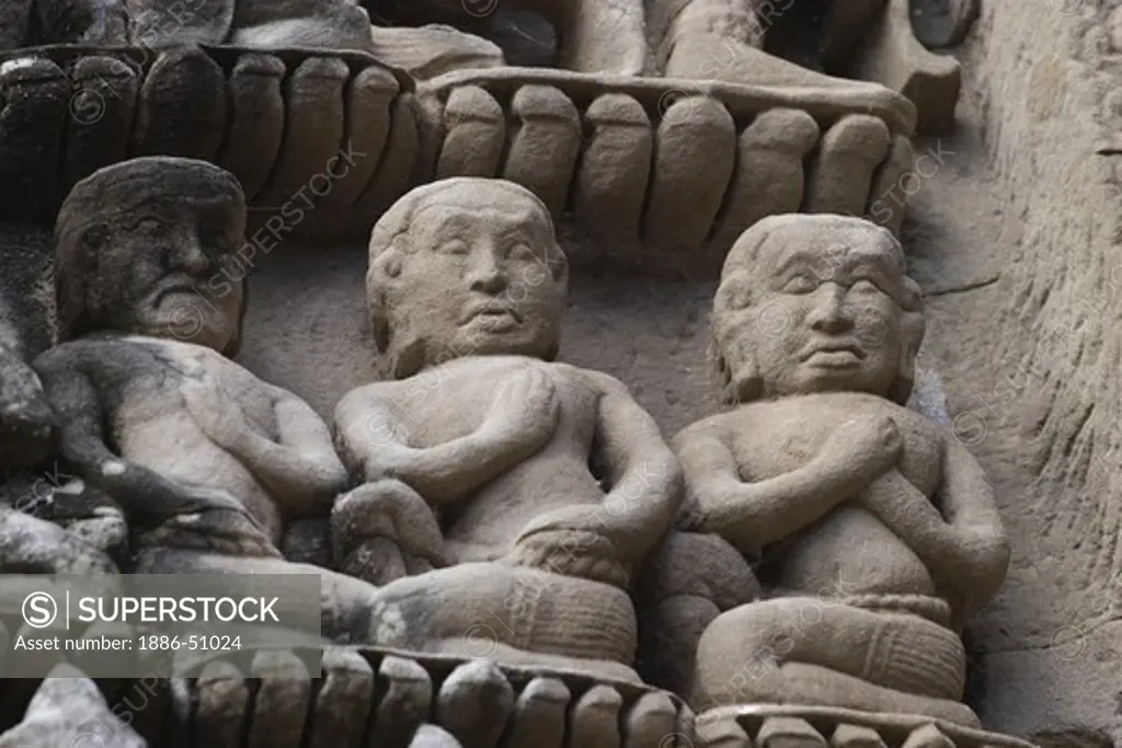 Three bas relief figures carved on the central Temple representing Mount Meru at Angkor Wat, built in the 11th century by Suryavarman the 2nd,  -  Cambodia