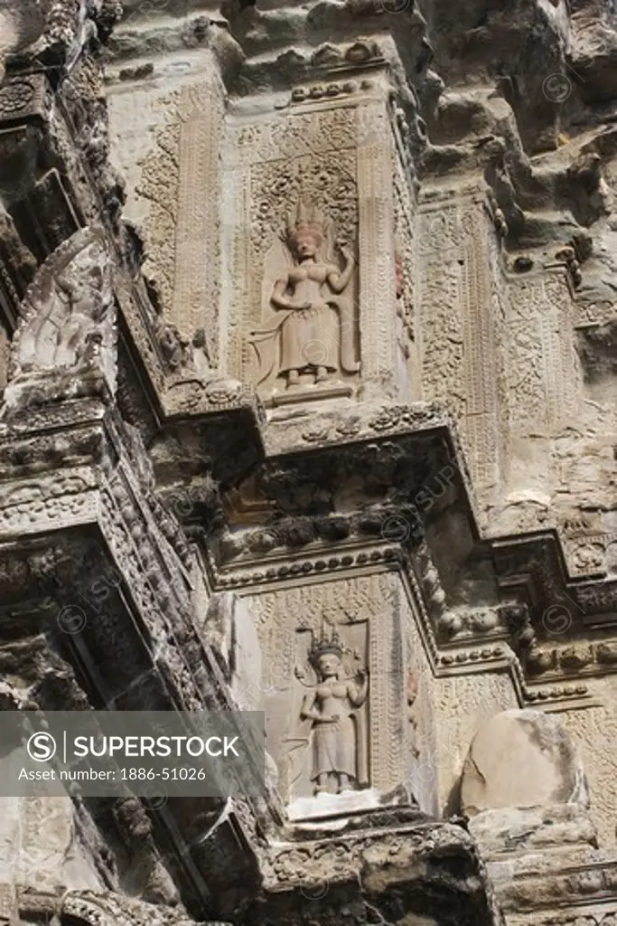 Two bas relief Apsaras carved on the central Temple representing Mount Meru at Angkor Wat, built in the 11th century by Suryavarman the 2nd,  -  Cambodia