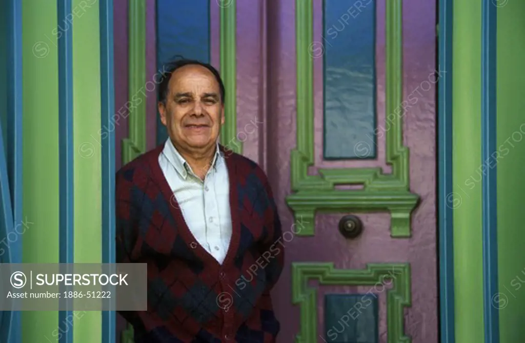 CHILEAN MAN who in the colorful doorway of his historic home on CERRO CONCEPTION - VALPARAISO, CHILE
