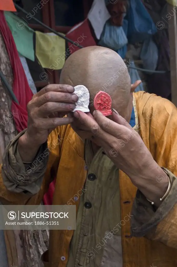 Tibetan Buddhist Tsa Tsas are received by a devout Buddhist practitioner in Danba - Sichuan Province, China