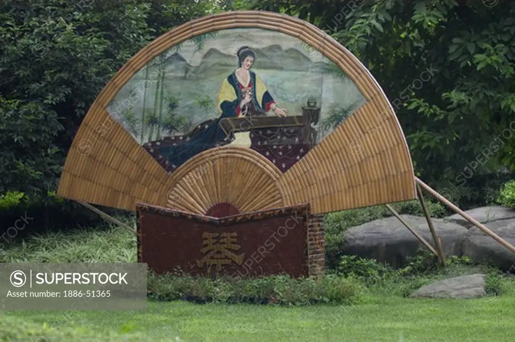 Giant fan with woman playing instrument in the River Viewing Pavilion Park - Sichuan Province, Chengdu, China