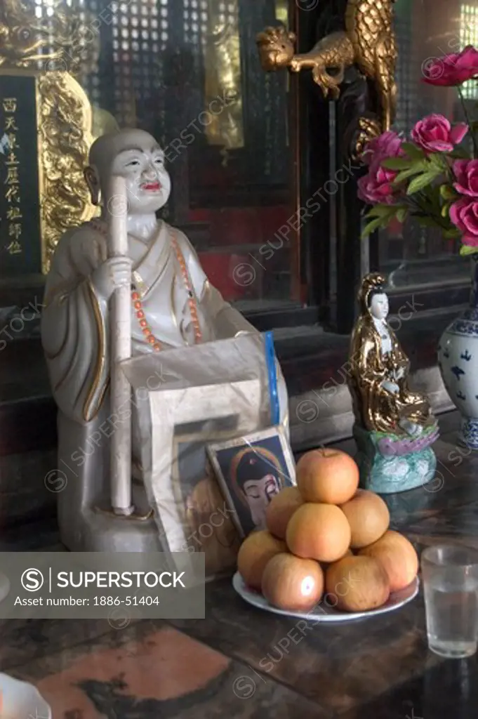 Oranges, offerings & Buddha statue at the Tang Dynasty Buddhist Wenshu Monastery  - Sichuan Province, Chengdu, China
