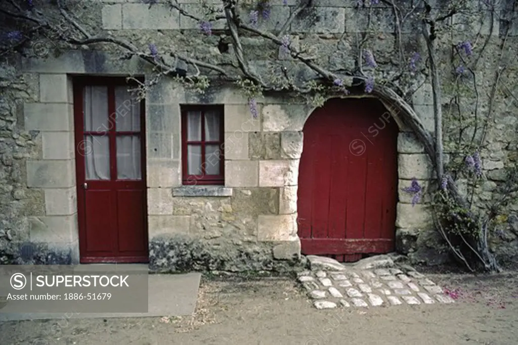 CHENENCOUX CASTLE WINERY with RED DOOR and PURPLE WISTERIA - LOIRE VALLEY, FRANCE
