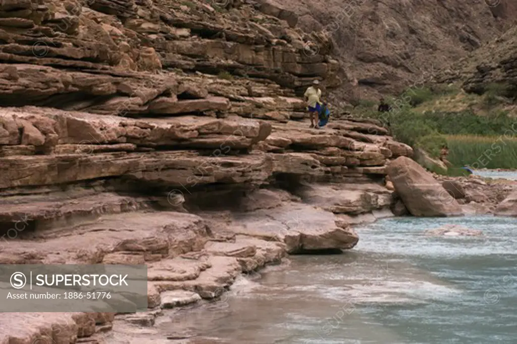 Hikers above the beautiful turquoise waters of the LITTLE COLORADO RIVER at mile 62 along the Colorado River - GRAND CANYON, ARIZONA