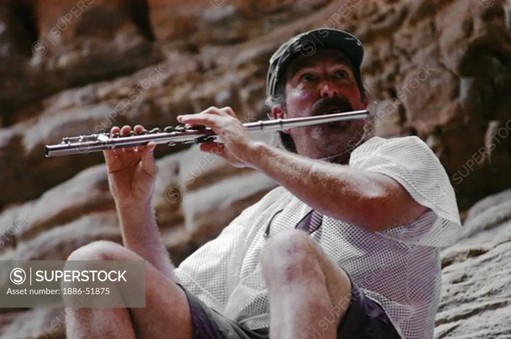 AMOS LOVELL plays flute in the slot canyon of BLACK TAIL CANYON NARROWS a truly spiritual experience - GRAND CANYON NATIONAL PARK, ARIZONA
