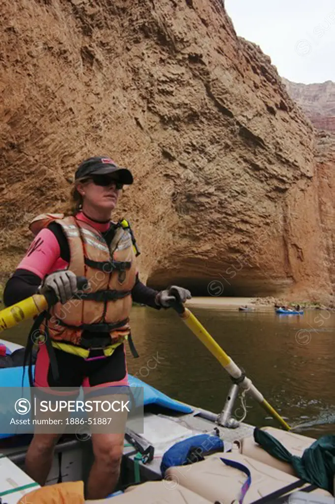 Raft guide Bonnie Pearsons approaches REDWALL CAVERN, a large cave found at mile 33 along the Colorado River - GRAND CANYON,  ARIZONA