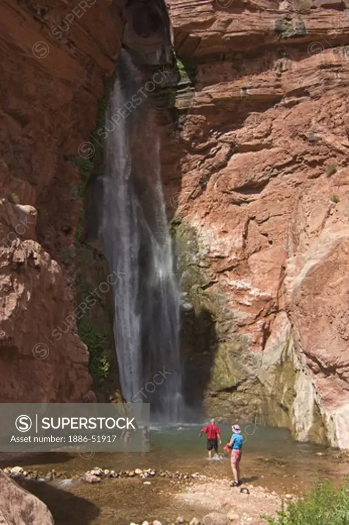 Hikers cool off at DEER CREEK FALLS at mile 136 is truly one of natures wonders - GRAND CANYON NATIONAL PARK, ARIZONA