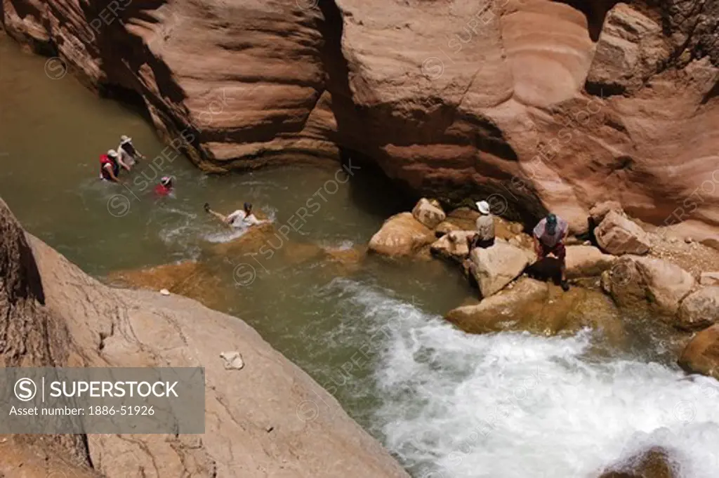 Visitors to HAVASU CREEK which comes out of the Havasupai Indian Reservation where hikers can enter - GRAND CANYON NATIONAL PARK, ARIZONA