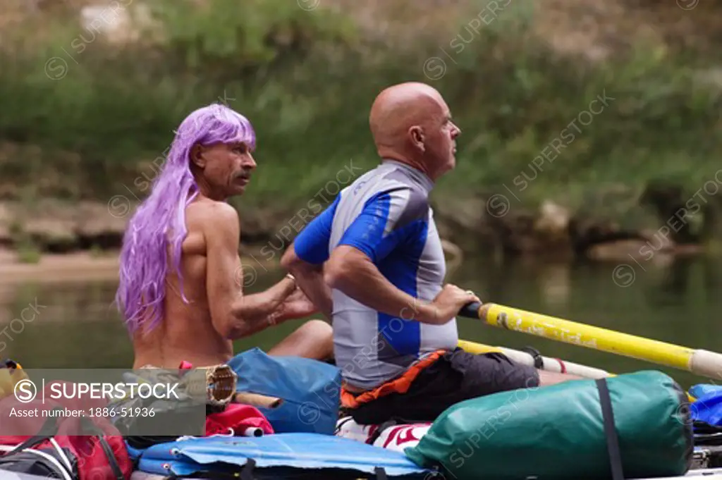 A purple wig is worn by a boater as a unique form of sun protection along the Colorado River - GRAND CANYON,  ARIZONA