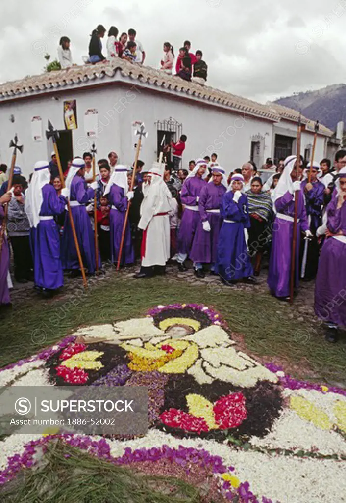 Purple-robed PENITENTS and ANGEL ALFOMBRA (carpet) made of sawdust and flowers for GOOD FRIDAY - ANTIGUA, GUATAMALA