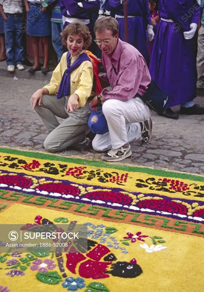 TOURISTS admire ALFOMBRA (carpet) with CATHOLIC symbolism and MAYAN inagery during GOOD FRIDAY - ANTIGUA, GUATAMALA