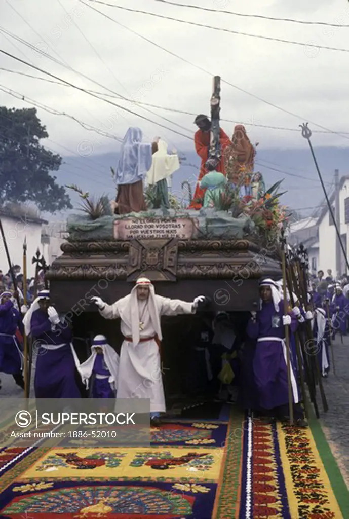 PRIESTS and PENITENTS with ANDA (wooden float sculpted in 1650) during GOOD FRIDAY PROCESSION - ANTIGUA, GUATAMALA