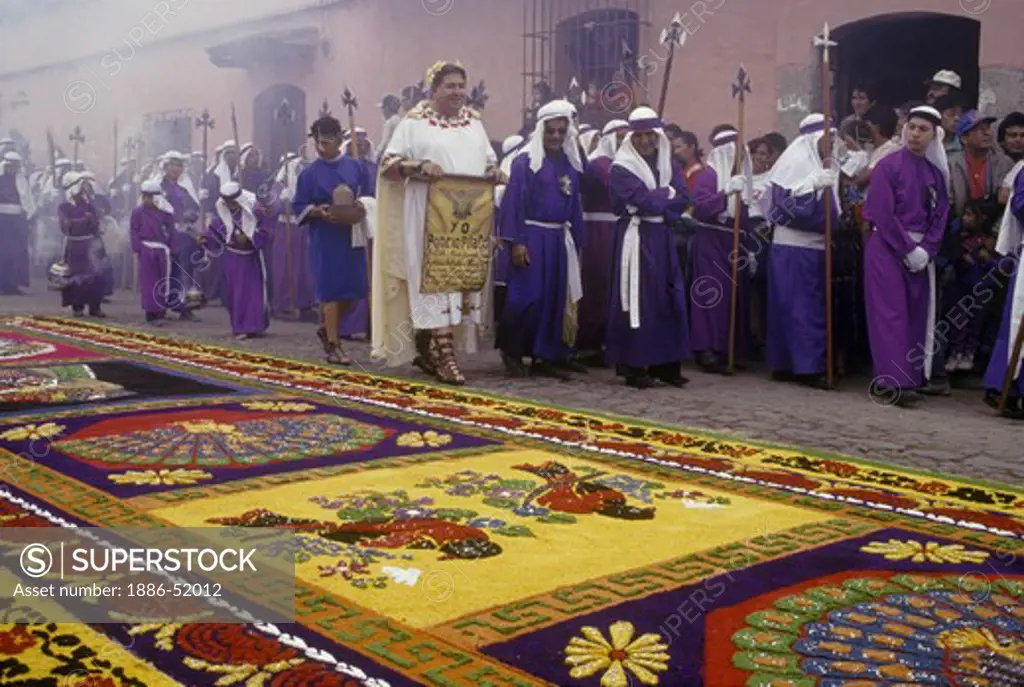 PENITENTS pass ALFOMBRA (carpet) with CATHOLIC symbolism and MAYAN imagery during GOOD FRIDAY - ANTIGUA, GUATAMALA