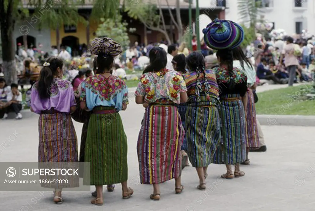 INDIGENOUS GUATEMALAN WOMEN in traditional brocade HUIPILS and handmade textiles - ANTIGUA, GUATEMALA