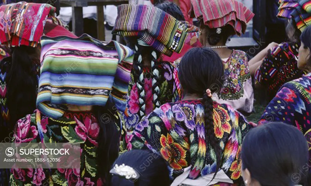 GUATAMALAN WOMEN of MAYA descent wearing traditional HUIPILS - CHICHICASTENANGO, GAUTAMALA