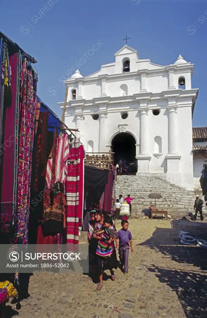 STREET MARKET selling traditional TEXTILES in front of SANTO TOMAS CHURCH - CHICHICASTENANGO, GUATEMALA