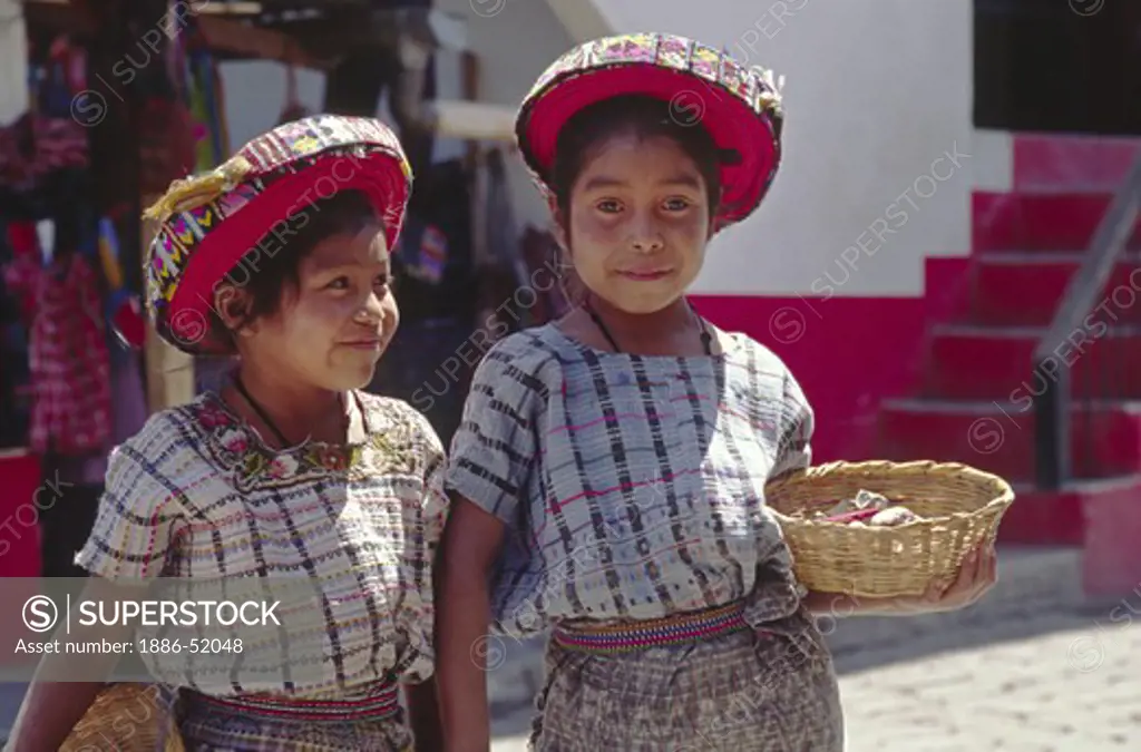 TZUTUJIL GIRLS in traditional handmade HUIPILS (blouses) and TOCAYALS (headresses) - SANTIAGO ATITLAN, GUATEMALA