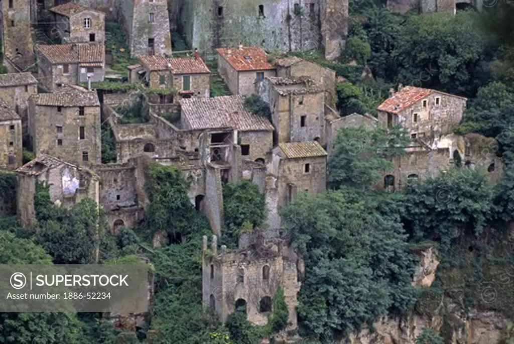 Houses hang onto the steep cliffs of SORANO,  a MEDIEVAL HILL TOWN with a 15th Cent. Palace & Castle - TUSCANY, ITALY