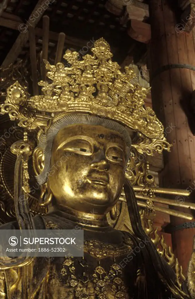 BUDDHIST DIETY inside TODAIJI TEMPLE, the largest wooden structure of its age in the world  - NARA, JAPAN