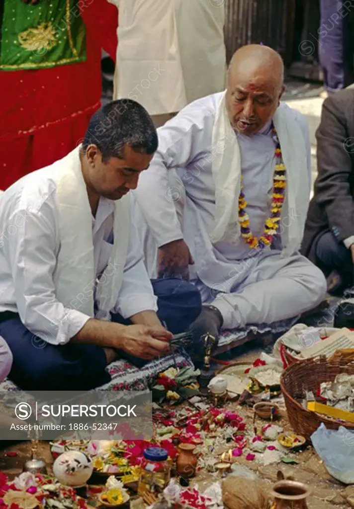 NEWARI MEN partake in Buddhist Puja, areligious function at SWAYAMBUNATH STUPA - KATHAMANDU, NEPAL