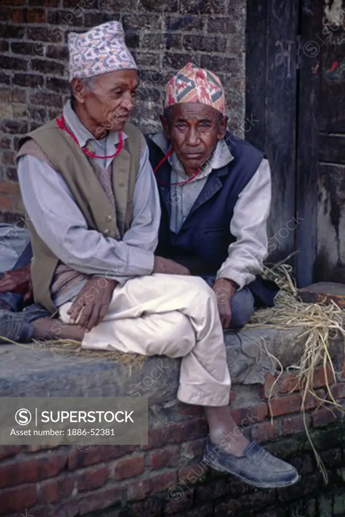 Old friends have a visit in the traditional town of BHAKTAPUR in the Kathamandu Valley of Nepal