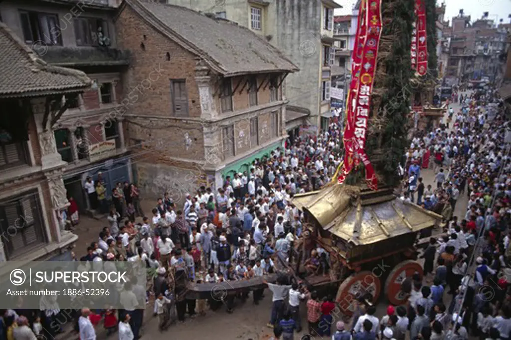 A giant CHARIOT carrying the RATO MACHENDRANATH DEITY moves through the streets at its festival - PATTAN, NEPAL