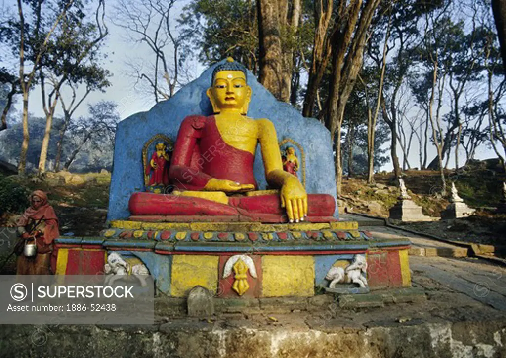 Statue of the BUDDHA on the pathway to SWAYAMBUNATH STUPA - KATHAMANDU, NEPAL