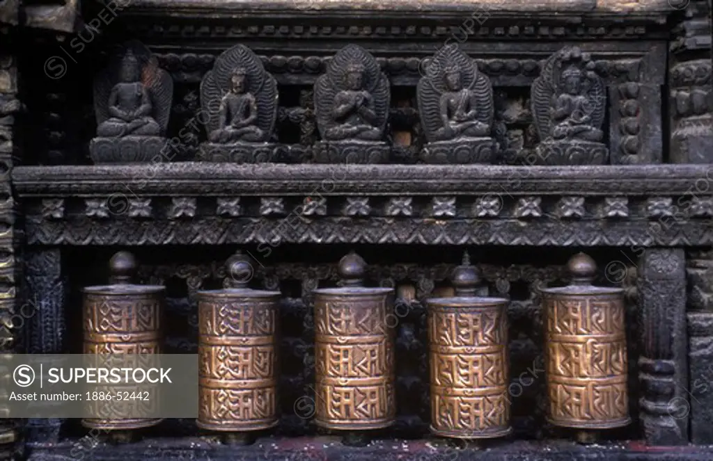PRAYER WHEELS & CARVED BUDDHAS at the SWAYAMBUNATH temple complex - KATHAMANDU, NEPAL