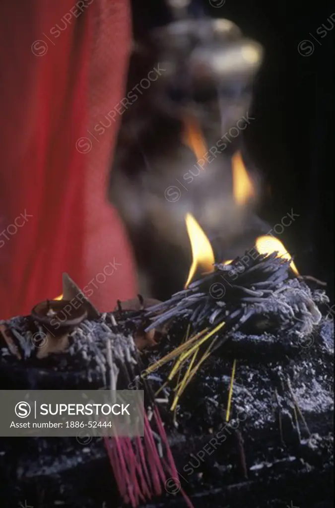 INCENSE BURNS at a BUDDHIST TEMPLE in the SWAYAMBUNATH TEMPLE COMPLEX - KATHAMANDU, NEPAL