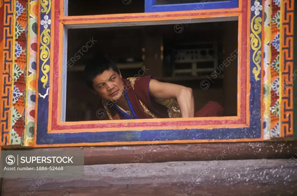 Nyingma sect monk watches the Cham dances for Padmasambava at Katok Monastery - Kham,  (Eastern, Tibet), Sichuan, China