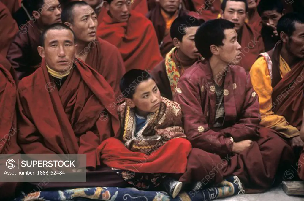 Nyingma monks watch the Buddhist Cham Dances, Katok Dorjeden Monastery - Kham, (E. Tibet), Sichuan Province, China