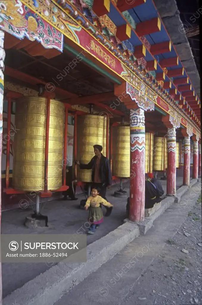 Tibetan Pilgrims spin Prayer Wheels Tagong  Monastery (Lhagang) - Kham (E. Tibet), Sichuan Province, China
